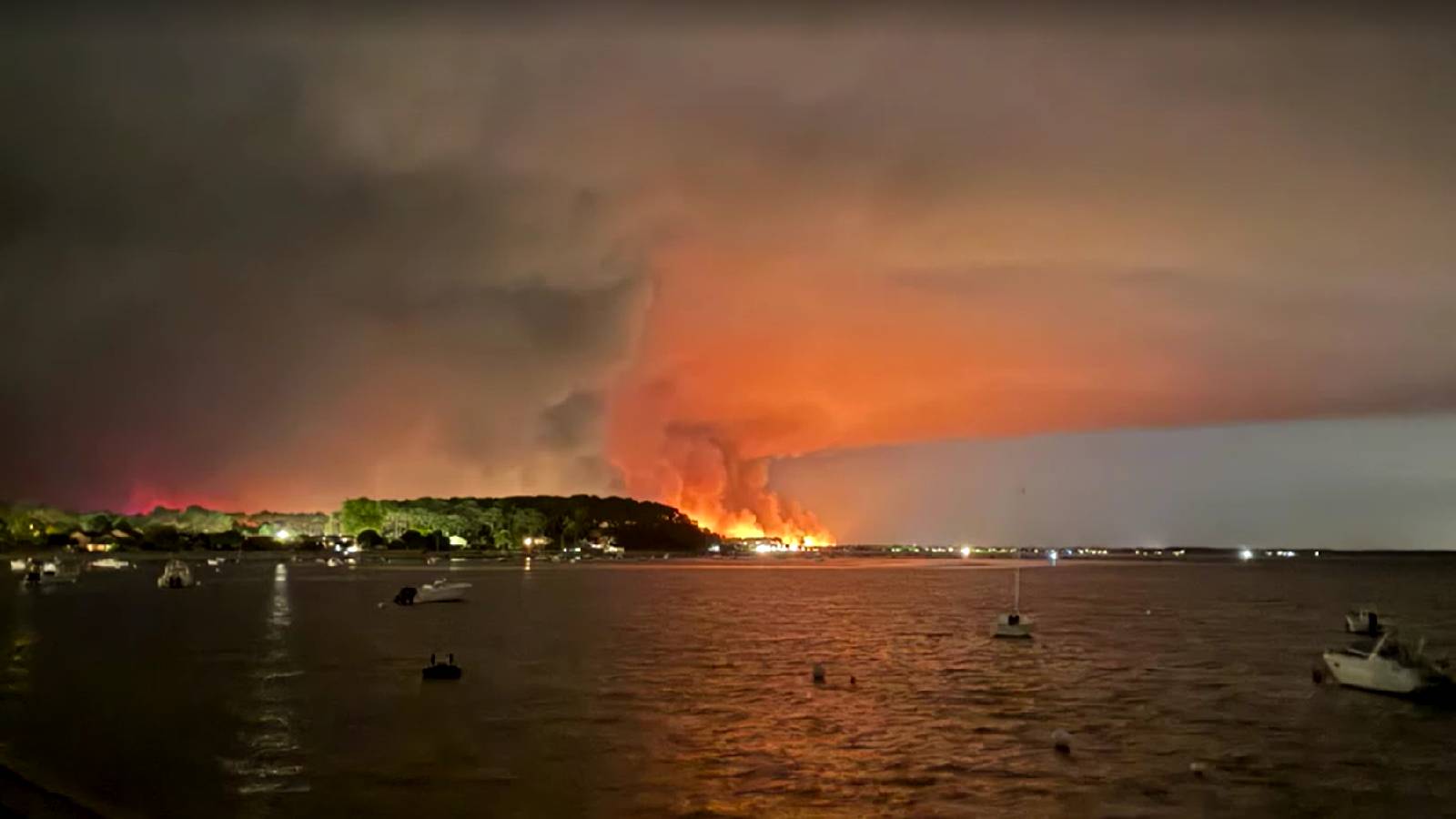 Over 200,000 people flee raging wildfires in France and Spain; some escaping by boat
