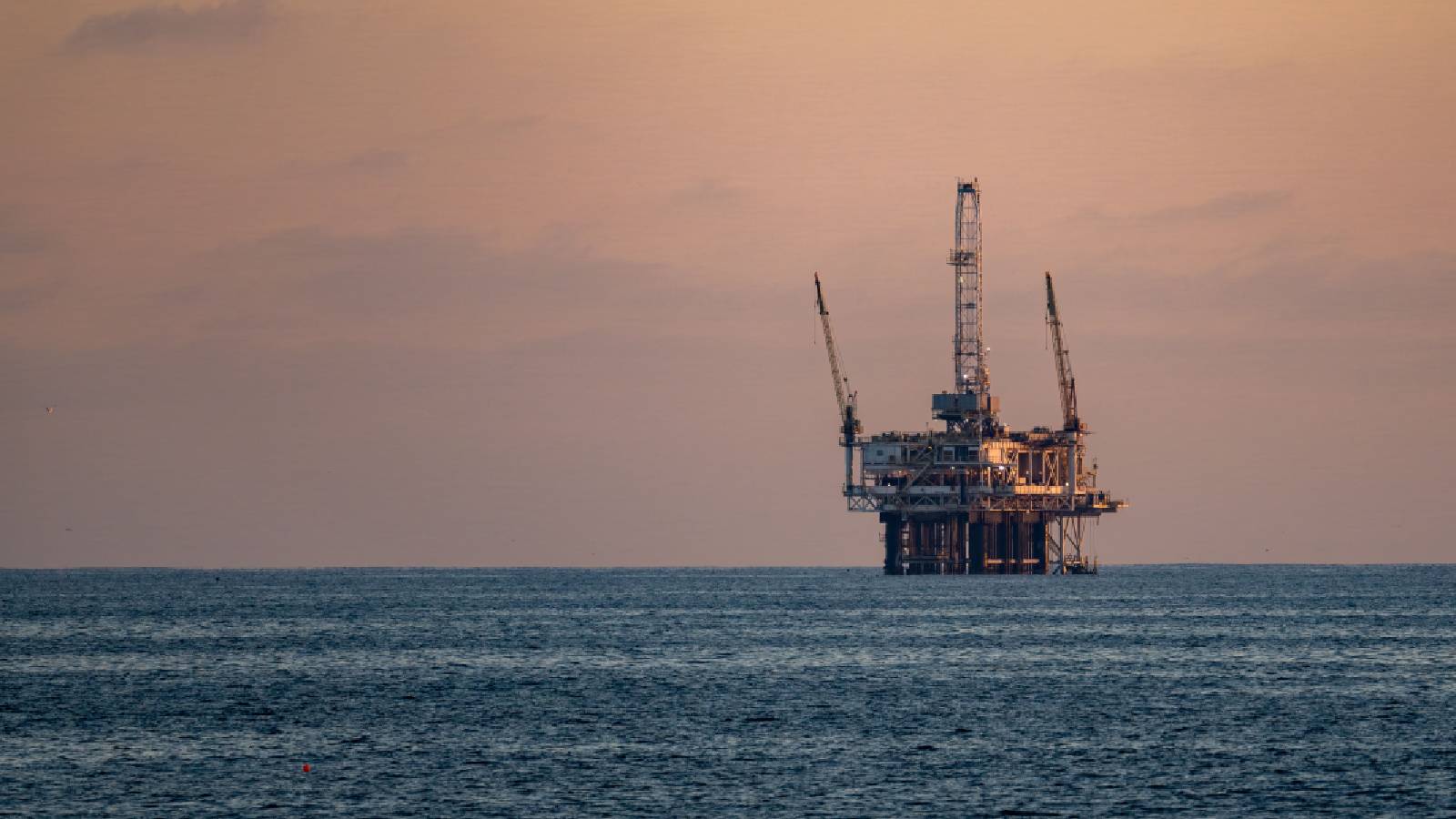 Wall Street drifts below its all-time high as oil prices keep swinging