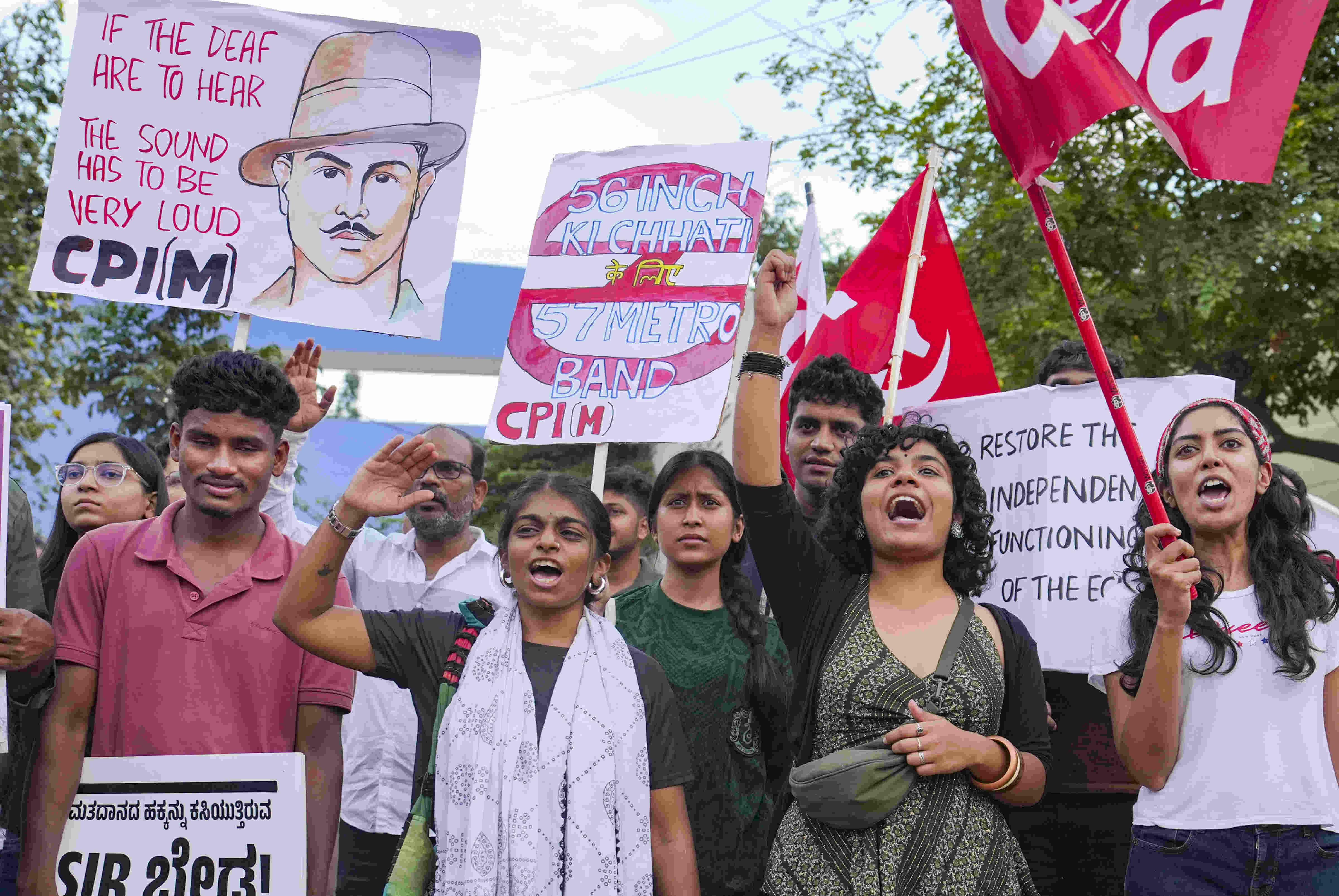 CPI (M) supporters hold posters during a protest against the Chief Election Commissioner (CEC) Gyanesh Kumar in Bengaluru
