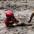 Rescuers battle waist-deep mud to search for missing after China's mudslide